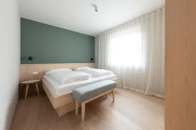 a bedroom with two beds and a window at Solis Apartments in Lana