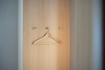 a wooden wall with a hanger in a room at Solis Apartments in Lana