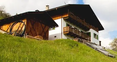 a building on top of a grassy hill at Galreidhof in Funes