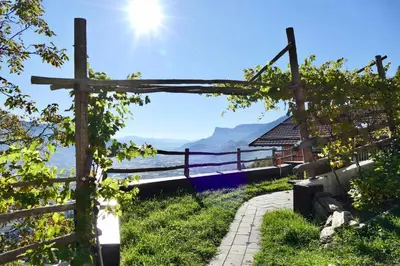 a view of the ocean through a wooden fence at Der Luemerhof in Marlengo