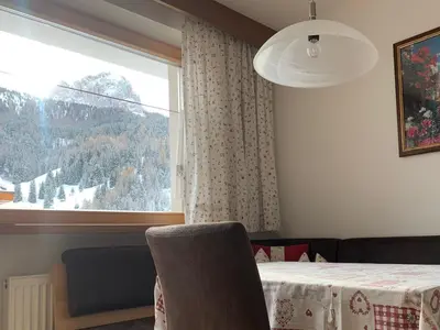 a room with a window and a table and a chair at Residence Ravisa Dolomites in Selva di Val Gardena