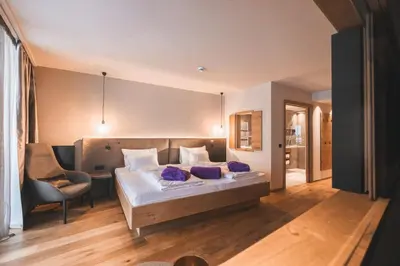 a bedroom with a bed with purple pillows on it at Hotel Familiamus in Maranza