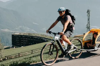 a man riding a bike down a road at Hotel Familiamus in Maranza