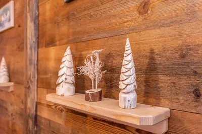 two vases sitting on a shelf with trees on it at Chalet Laura in Alleghe