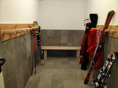 a room with a bench and a bunch of skis at Chalet Laura in Alleghe