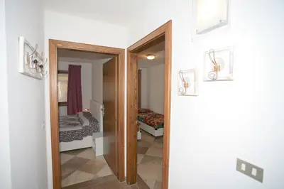 a hallway with a door leading to a bedroom at Residence Roacia in Alba di Canazei