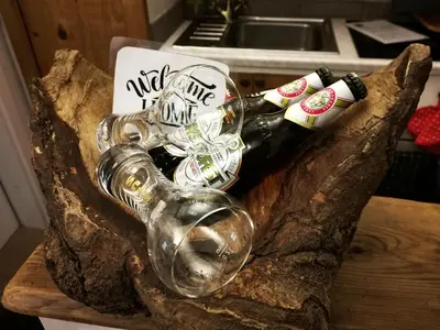 two wine glasses and a bottle on a wooden table at Villetta Italia IT.CU in Merano