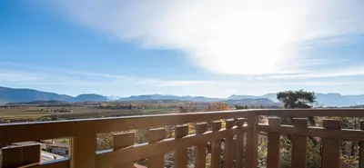 a view of the mountains from the deck of a house at Appartement Marlene in Appiano sulla Strada del Vino