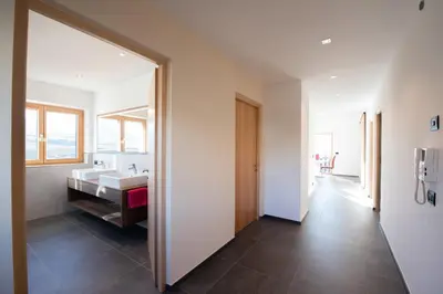 a bathroom with a sink and a large mirror at Appartement Marlene in Appiano sulla Strada del Vino