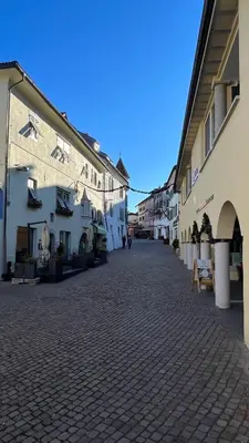 a cobblestone street in a town with white buildings at NEW Suite mar e monti in Appiano sulla Strada del Vino