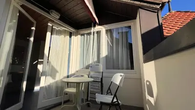 a small balcony with a table and two chairs at NEW Suite mar e monti in Appiano sulla Strada del Vino