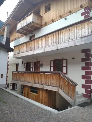 a building with wooden balconies on the side of it at Botton d'oro in Campitello di Fassa