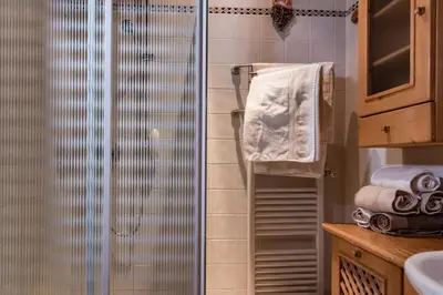 a shower with a glass door in a bathroom at SciliarGuestHouse-due piani parcheggio privato in Castelrotto