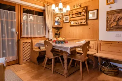 a dining room with a wooden table and chairs at SciliarGuestHouse-due piani parcheggio privato in Castelrotto