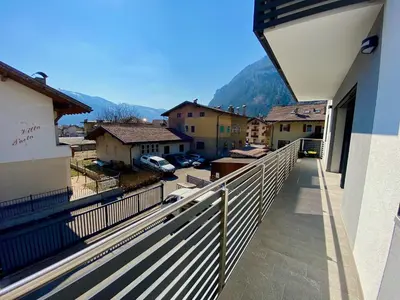 a balcony of a building with a view of a town at Villa Dada in Predazzo