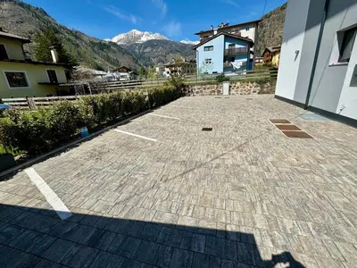 a parking lot with a mountain in the background at Villa Dada in Predazzo