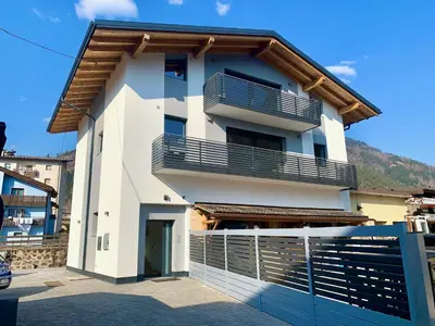 a white building with a balcony on top of it at Villa Dada in Predazzo
