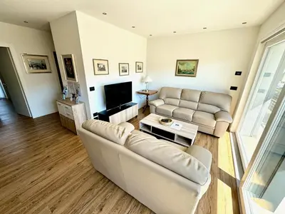 a living room with two couches and a television at Villa Dada in Predazzo