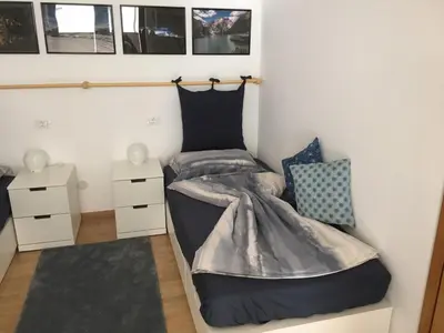 a bedroom with two beds and two night stands at LaSiesta Merano in Merano