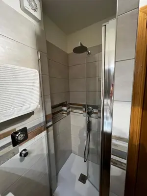 a bathroom with a shower with a glass door at LaSiesta Merano in Merano