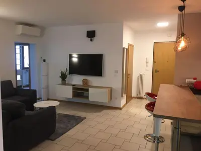 a living room with a flat screen tv on a wall at LaSiesta Merano in Merano