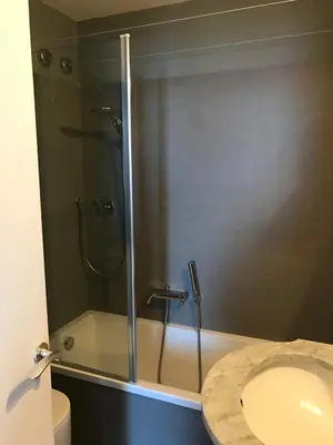 a bathroom with a shower with a sink and a toilet at Appartamento con vista sull'Alpe di Siusi in Bulla