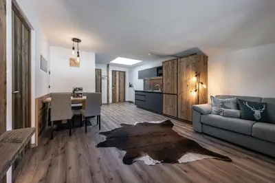 a living room with a couch and a table at Mesnerhof in Valles