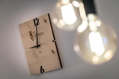a clock is hanging on a wall with lights at Mesnerhof in Valles