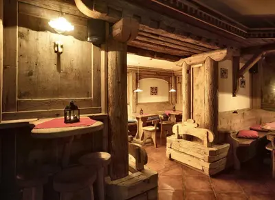 a restaurant with tables and chairs in a room at Hotel Majon Miramonti in Canazei