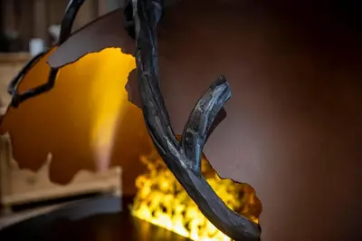 a halloween pumpkin with a fire in the background at Hotel Majon Miramonti in Canazei