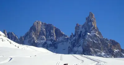 a snow covered mountain with a ski trail at Casette Margherita in Fiera di Primiero