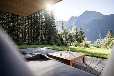 a room with a table and a view of a mountain at Stelza Nature Chalet in Val di Vizze