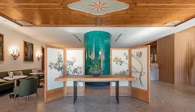 two pictures of a front door of a building at Faloria Mountain Spa Resort in Cortina dʼAmpezzo