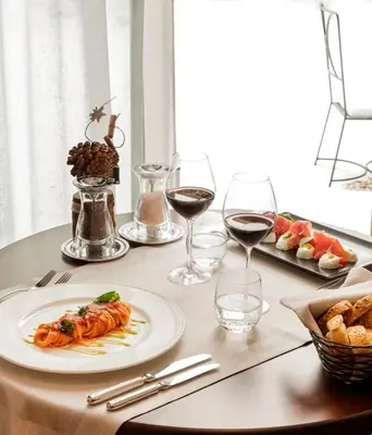 a buffet with meats and other foods on a table at Faloria Mountain Spa Resort in Cortina dʼAmpezzo