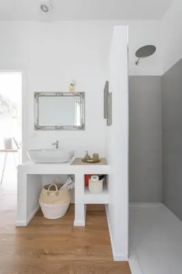 a white bathroom with a sink and a mirror at Dolomiti 65 mq new flat in the center of Bolzano in Bolzano