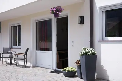 a house with a door with flowers on it at dolomites view apartment in Rasun di Sopra
