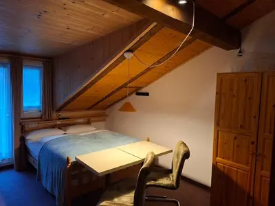 a bedroom with a bed and a table in a room at Gassermühle - Studio Appartments in Eggen