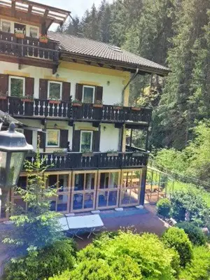 a large house with a balcony on top of it at Gassermühle - Studio Appartments in Eggen