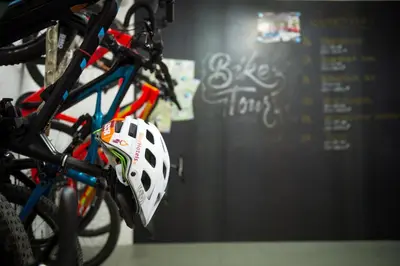 a white helmet is hanging from a bicycle at KRONE eat drink stay in Bressanone