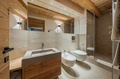 a living room with a couch and a fireplace at Chalet Socrepes - Dolomiti Skyline in Cortina dʼAmpezzo