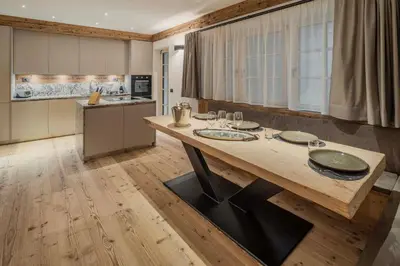 a bedroom with a large bed and a large window at Chalet Socrepes - Dolomiti Skyline in Cortina dʼAmpezzo