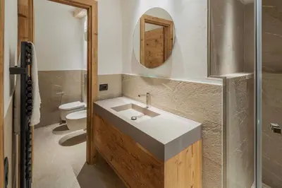 a bathroom with a sink and a toilet at Chalet Socrepes - Dolomiti Skyline in Cortina dʼAmpezzo