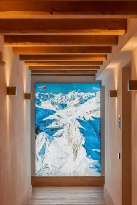 a painting of snow covered mountains on a wall at Royal Hotel Cortina in Cortina dʼAmpezzo
