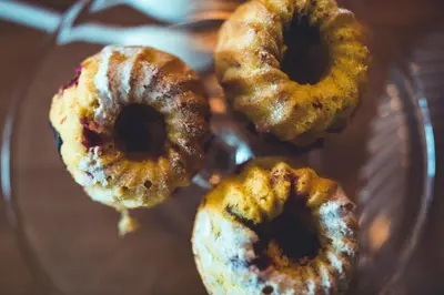 a group of donuts sitting on a glass plate at Gourmet - Boutique Hotel Tanzer in Falzes