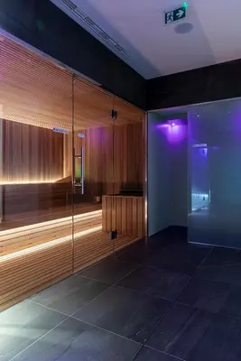 a room with a glass shower with purple lights at Stadt Hotel Città in Bolzano