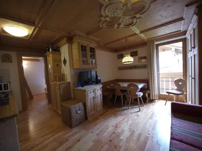 a kitchen and dining room with a table and chairs at Appartamento Brentegani in Arabba