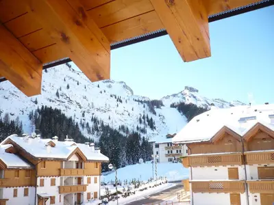 a view of a town with snow covered buildings at Appartamento Brentegani in Arabba