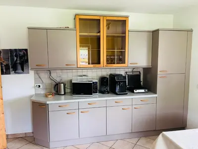 a kitchen with white cabinets and appliances at Ciasa Fam Comploi in San Vigilio Di Marebbe
