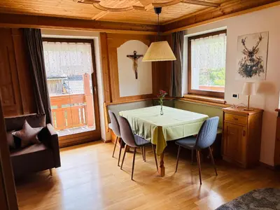 a dining room with a table and chairs at Ciasa Fam Comploi in San Vigilio Di Marebbe