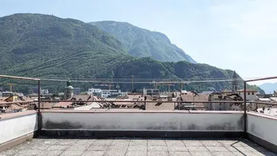 a view of a city with a mountain in the background at Erker Apartment in Bolzano